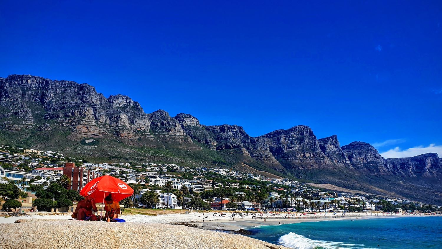 Camps-Bay-Cape-Town banner picture red umbrella on beach